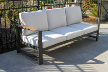 Load image into Gallery viewer, Outdoor sofa with white cushions on a patio