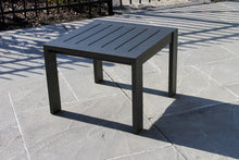 Load image into Gallery viewer, Black outdoor table on a stone patio
