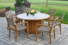 Load image into Gallery viewer, Round wooden outdoor table with chairs on a patio