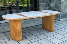 Load image into Gallery viewer, Outdoor dining table with marble-like surface on a stone patio