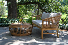 Load image into Gallery viewer, Outdoor patio set with wicker table and chair in a garden setting