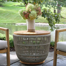 Load image into Gallery viewer, Outdoor side table with a vase of flowers