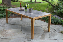 Load image into Gallery viewer, Outdoor dining table with a stone top on a patio