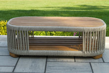 Load image into Gallery viewer, Oval outdoor coffee table with woven design on a patio