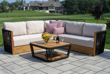 Load image into Gallery viewer, Outdoor patio set with a sectional sofa and coffee table on a patio.