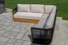 Load image into Gallery viewer, Outdoor patio sectional sofa with cushions on a stone patio.