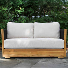 Load image into Gallery viewer, Wooden outdoor love seat with white cushions in a garden setting
