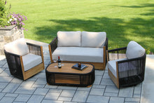 Load image into Gallery viewer, Outdoor patio furniture set with white cushions on a stone patio.