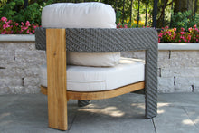 Load image into Gallery viewer, Outdoor chair with woven backrest and wooden armrest on a patio