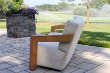 Load image into Gallery viewer, Chair with wooden armrests on a patio with a garden view