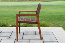 Load image into Gallery viewer, Wooden chair with woven seat and backrest on a patio with grass in the background
