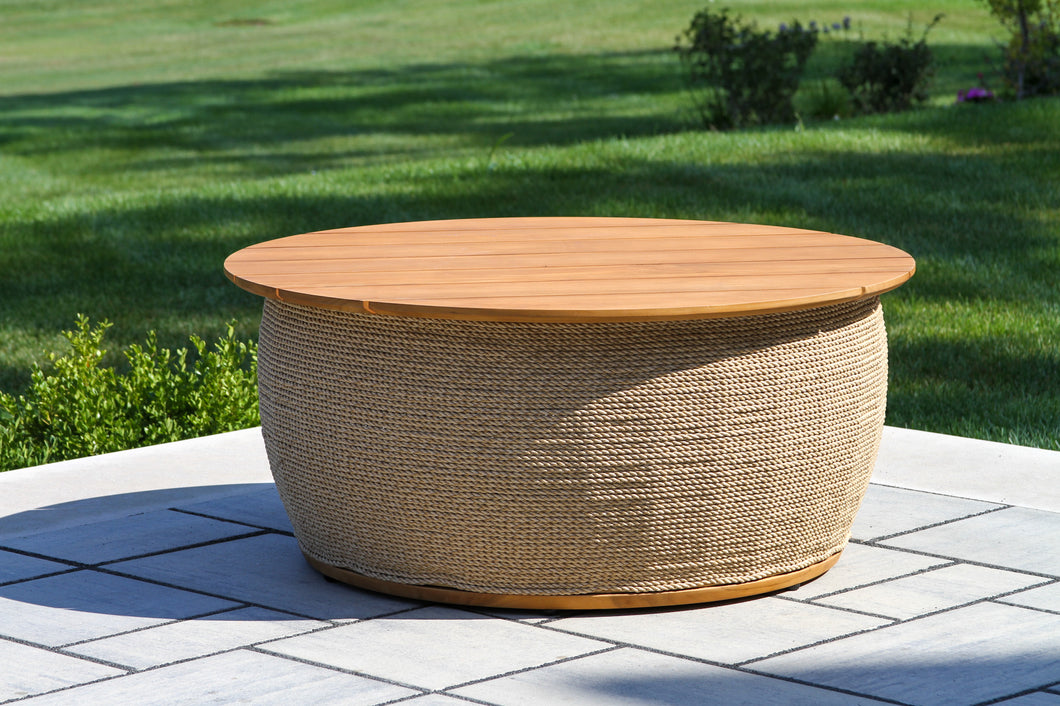 Round outdoor coffee table with wooden top and woven base