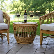 Load image into Gallery viewer, Wicker side table with wine bottle and glasses on a patio

