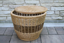 Load image into Gallery viewer, Wicker side table with wooden top on a stone patio
