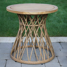 Load image into Gallery viewer, Round wooden table with wicker base on a paved surface with grass in the background
