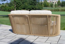Load image into Gallery viewer, Wicker outdoor sofa with white cushions on a patio
