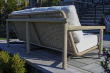 Load image into Gallery viewer, Wood frame outdoor sofa with white cushions on a patio
