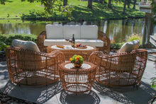 Load image into Gallery viewer, Outdoor patio set with wicker chairs and table by a pond
