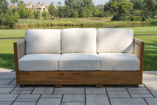 Load image into Gallery viewer, Wooden outdoor sofa with white cushions on a patio
