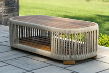 Load image into Gallery viewer, Oval outdoor coffee table with wooden top and rope-like base on a patio
