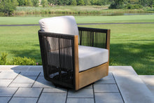 Load image into Gallery viewer, Modern outdoor chair with white cushion on a patio
