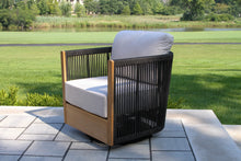 Load image into Gallery viewer, Modern outdoor swivel chair with white cushion on a patio
