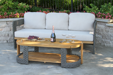 Load image into Gallery viewer, Outdoor patio set with a sofa and coffee table on a stone patio.
