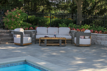 Load image into Gallery viewer, Outdoor patio area with a pool, furniture, and decorative elements.
