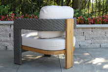 Load image into Gallery viewer, Outdoor chair with wicker backrest and wooden frame on a patio
