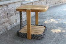 Load image into Gallery viewer, Wooden side table with woven base on a stone patio
