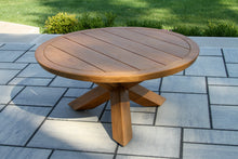 Load image into Gallery viewer, Wooden round table on a stone patio with grass in the background
