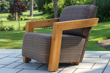 Load image into Gallery viewer, Outdoor chair with wicker seat and wooden frame on a patio
