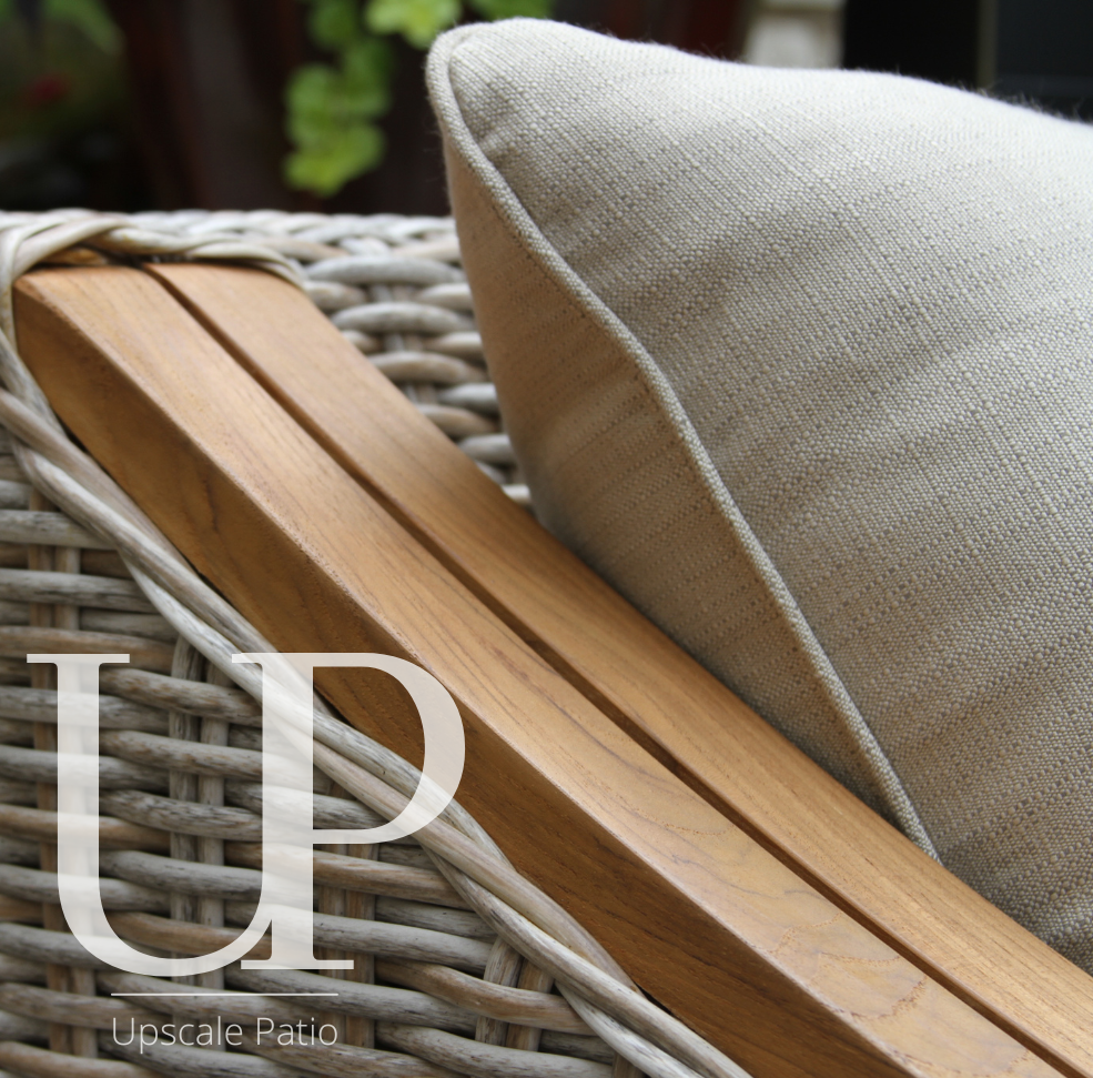 Wicker chair with wooden armrests and a beige cushion, featuring 'Upscale Patio' branding.